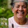 Maria Rodriguez smiling in a garden